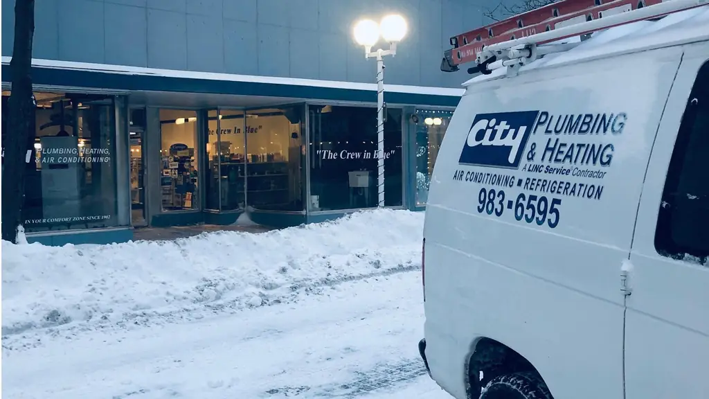 A City Plumbing van outside the State Street storefront on a snowy downtown morning.