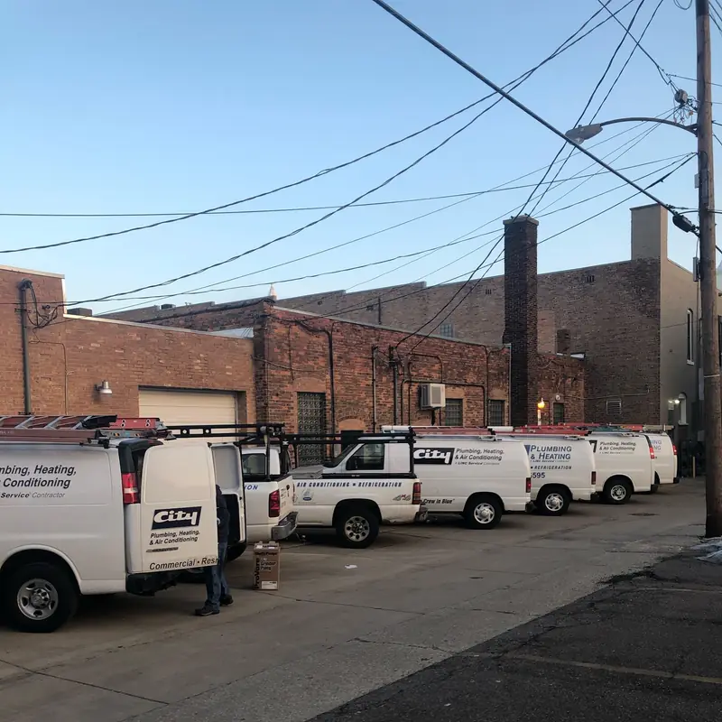 The City Plumbing van fleet lined up in the alley behind the State Street shop.