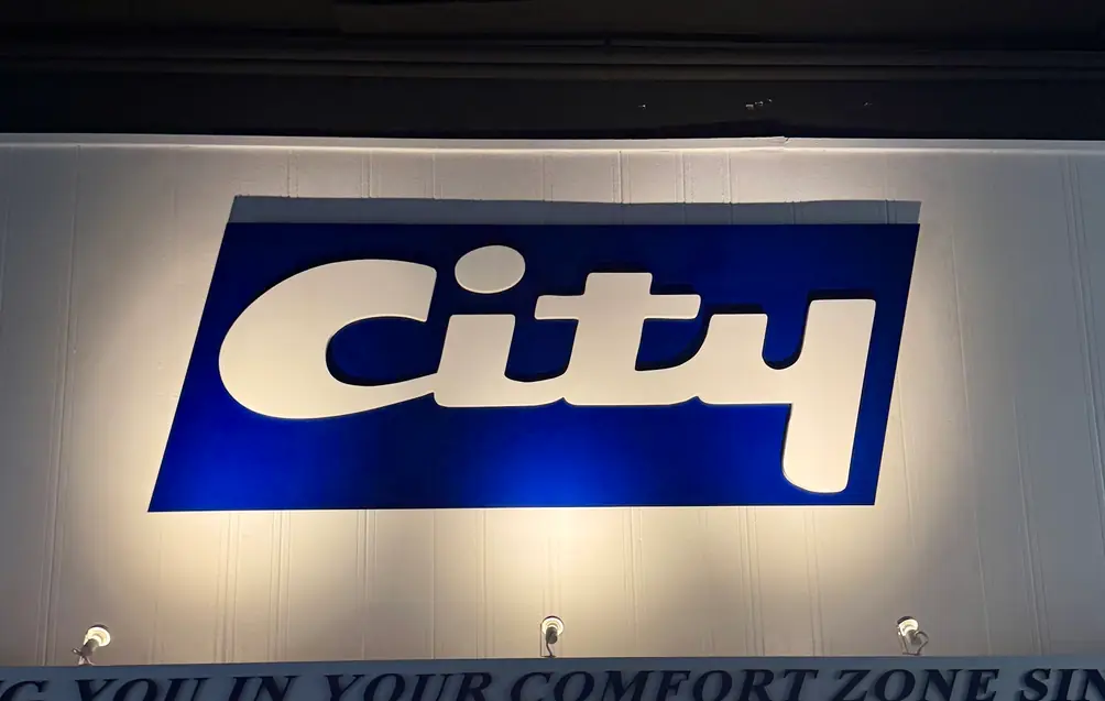 The illuminated City sign on the State Street building at night.